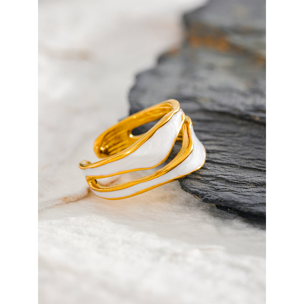 Gold and white ring on a textured surface